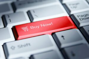 Red 'buy now!' button on a computer keyboard