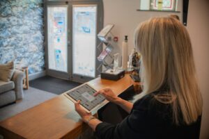 Woman using a tablet at a reception desk