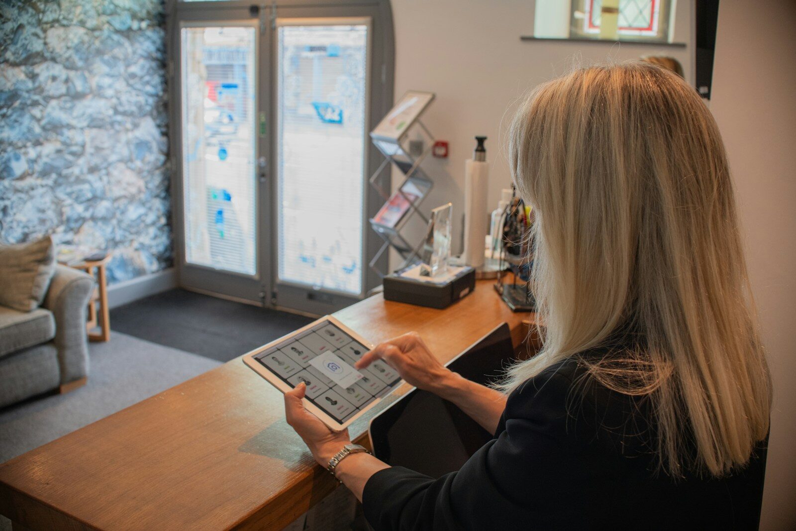 Woman using a tablet at a reception desk